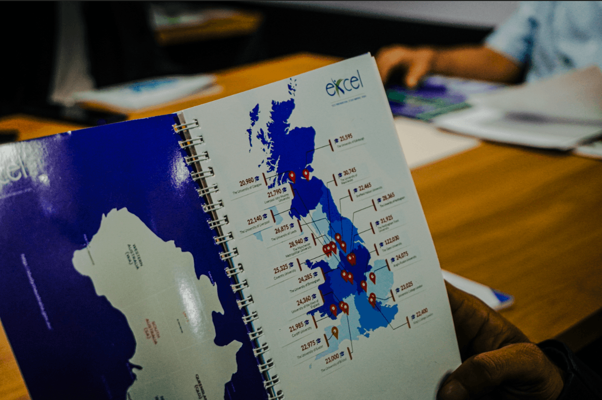 Team of consultants pointing at a world map